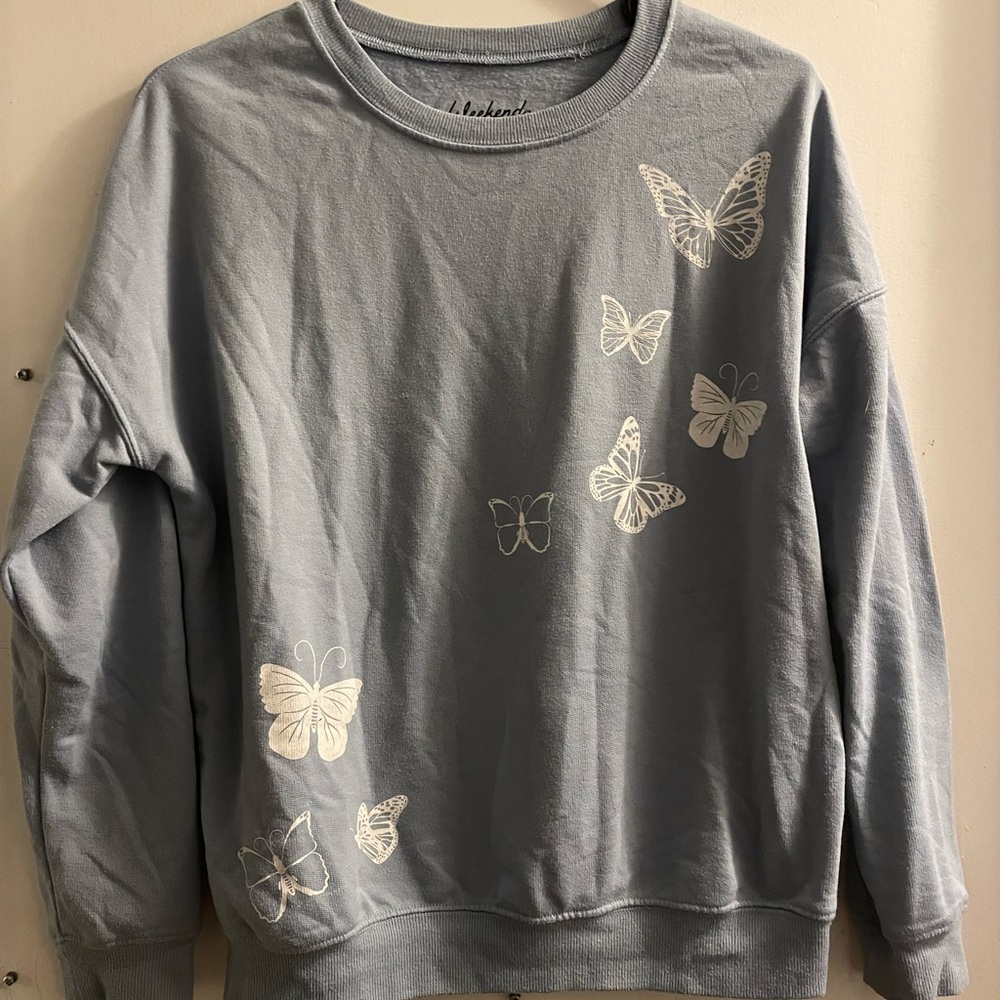 Light blue crewneck with butterflies.